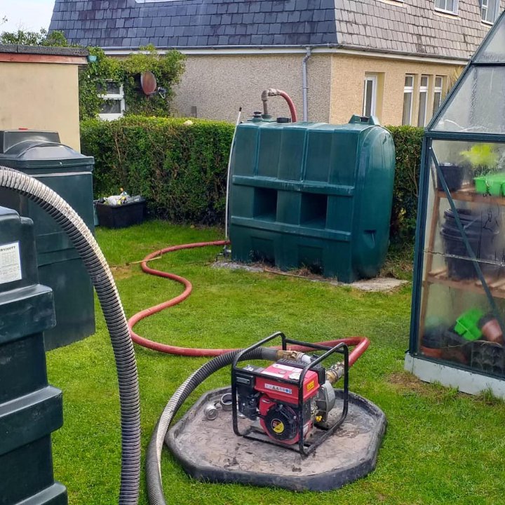 oil tank being emptied into a holding tank